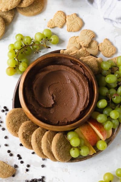 Plate of chocolate dessert hummus surrounded by cookies and fruit