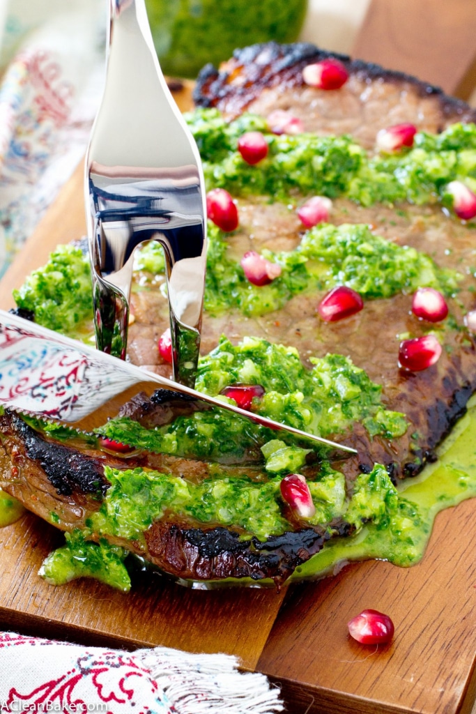 This juicy flank steak is drizzled with homemade chimichurri and plump pomegranate seeds for a simple, flavorful dinner! (gluten free, paleo and low carb)