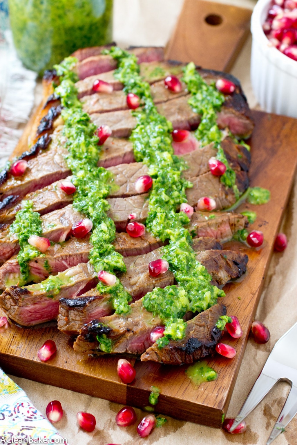 This juicy flank steak is drizzled with homemade chimichurri and plump pomegranate seeds for a simple, flavorful dinner! (gluten free, paleo and low carb)