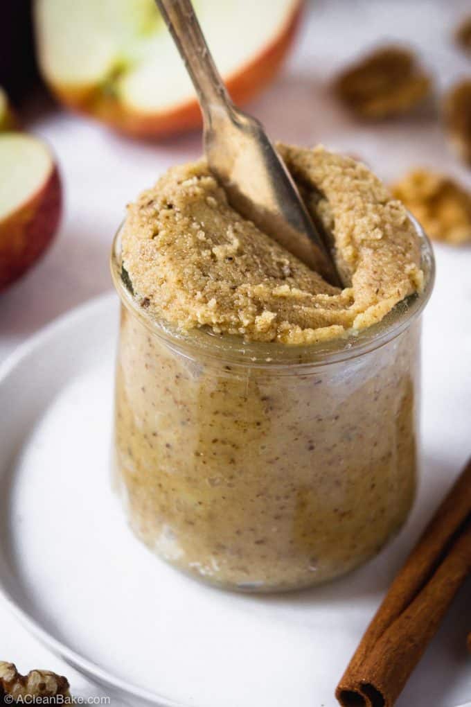 Jar of apple cinnamon walnut butter with a knife sticking out of it