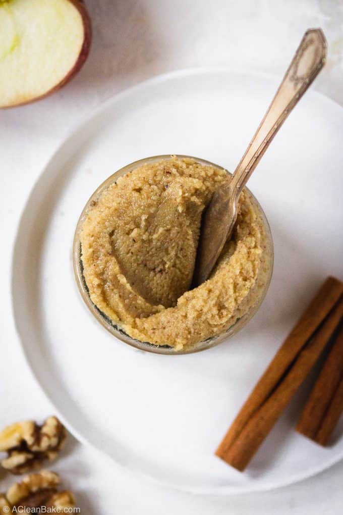 Overhead photo of jar of apple cinnamon walnut butter with butter knife stuck in it