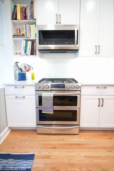 White and Stainless Kitchen with Subway Tile and Marble-Look Countertops (via acleanbake.com)