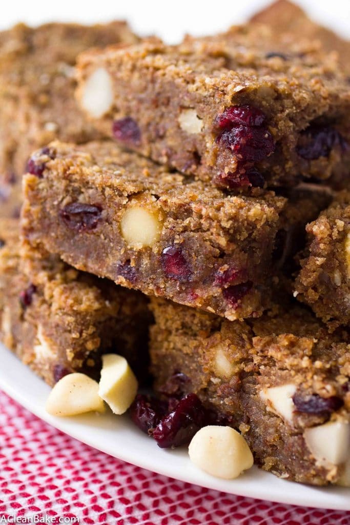Gooey and decadent cranberry white chocolate macadamia nut blondies. Perfect for Valentine's Day, don't you think? (gluten free, paleo friendly, naturally sweetened, low carb) 