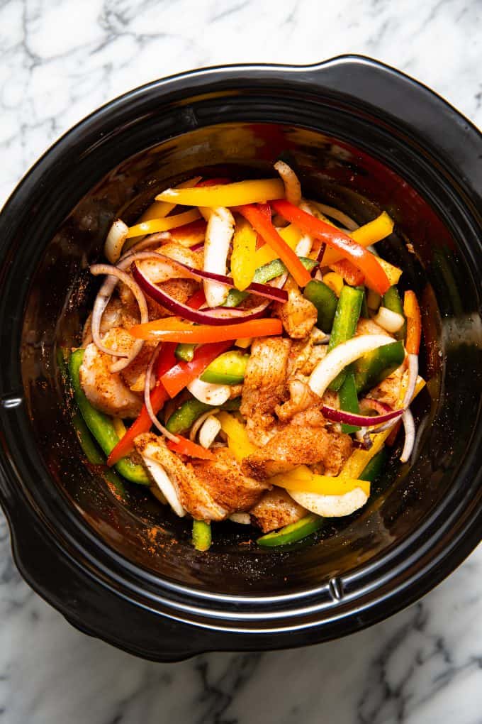 Slow cooker crockpot chicken fajitas in the slow cooker bowl before cooking