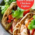 Two slow cooker chicken fajitas in gluten free and paleo tortillas with a garnish of cilantro