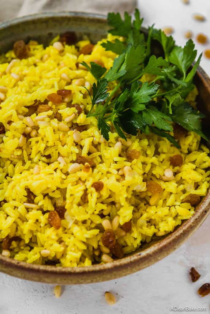 Turmeric rice with nuts and raisins in a bowl