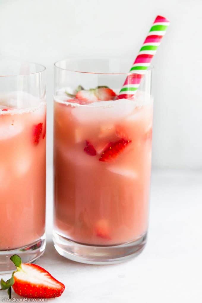 Homemade pink drink recipe in glasses with strawberry slices and straws