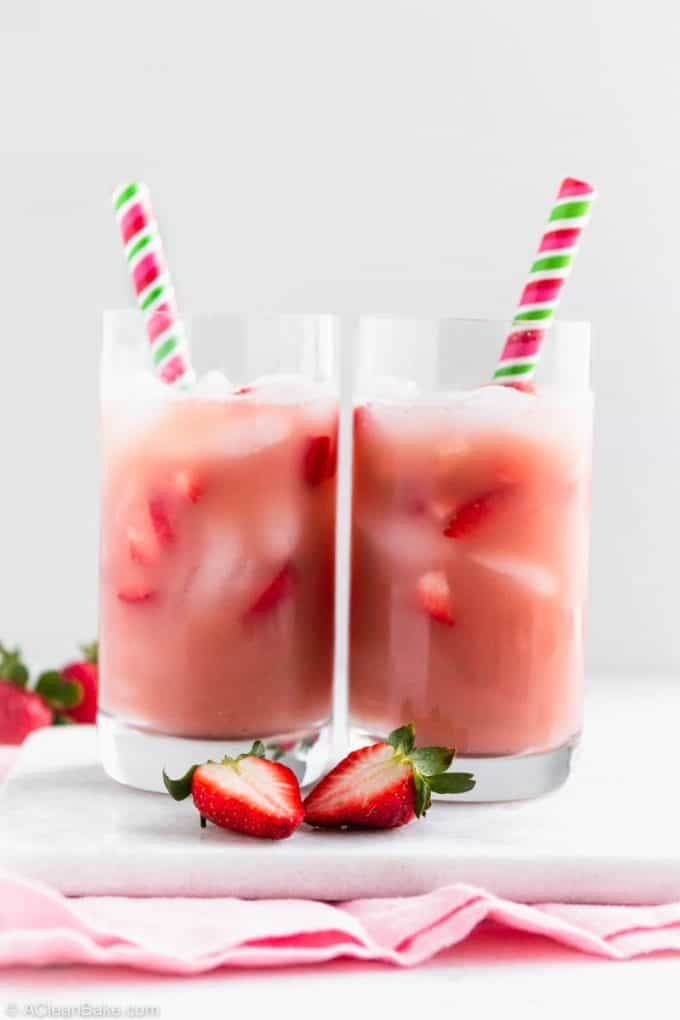 Homemade pink drink recipe in glasses with strawberry slices and straws