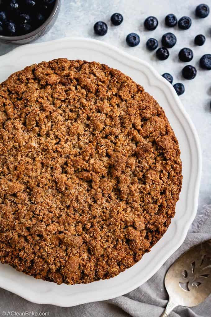 Blueberry crumb cake on a plate with fresh blueberry garnish and spatula