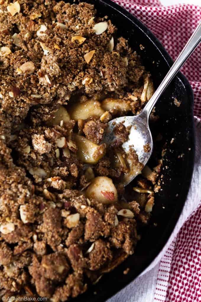 Batch of vegan paleo apple crisp in a pan with a spoonful removed