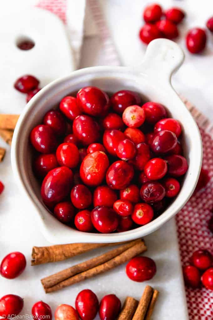 Measuring cup of cranberries for paleo cranberry sauce