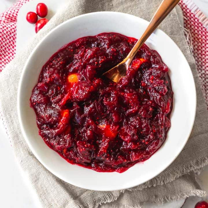 This paleo cranberry sauce is the easies Thanksgiving dinner side you'll ever make. It requires only 4 ingredients (plus water) and about 15 minutes of your time, and is naturally sweetened with coconut sugar and orange juice. Don't stress about the sides this year! #paleo #paleorecipes #paleothanksgiving #cleaneating #cleaneatingrecipes #glutenfreethanksgiving #glutenfreerecipes #sidedish #thanksgivingside #vegan #veganrecipes #veganthanksgiving #cranberry #cranberryrecipes #realfood