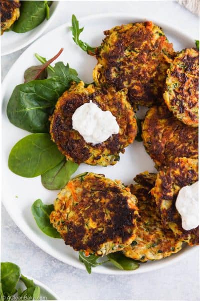 Paleo gluten free vegetable fritter with yogurt sauce on a plate