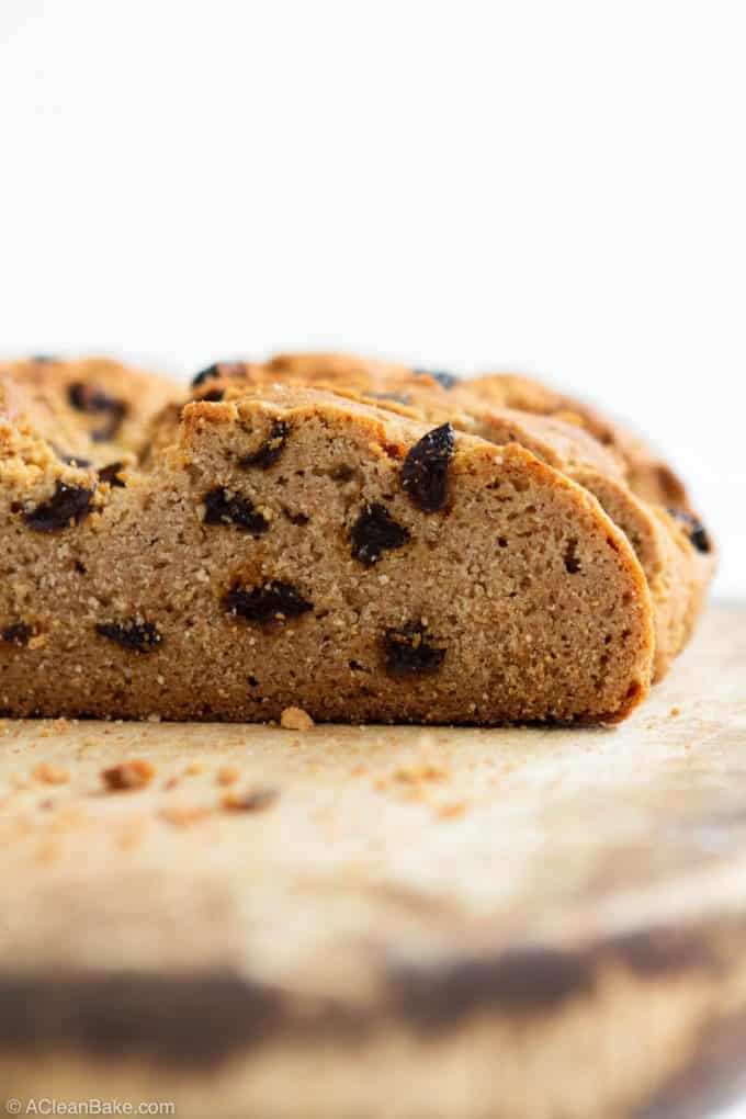 Loaf of paleo gluten free irish soda bread on a cutting board, sliced open