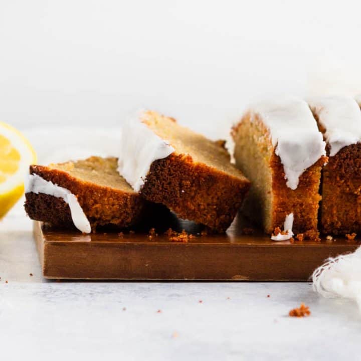 Sliced loaf of paleo and gluten free lemon pound cake on a cutting board