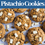 Gluten free & Paleo Pistachio White Chocolate Chunk Cookies on a blue counter