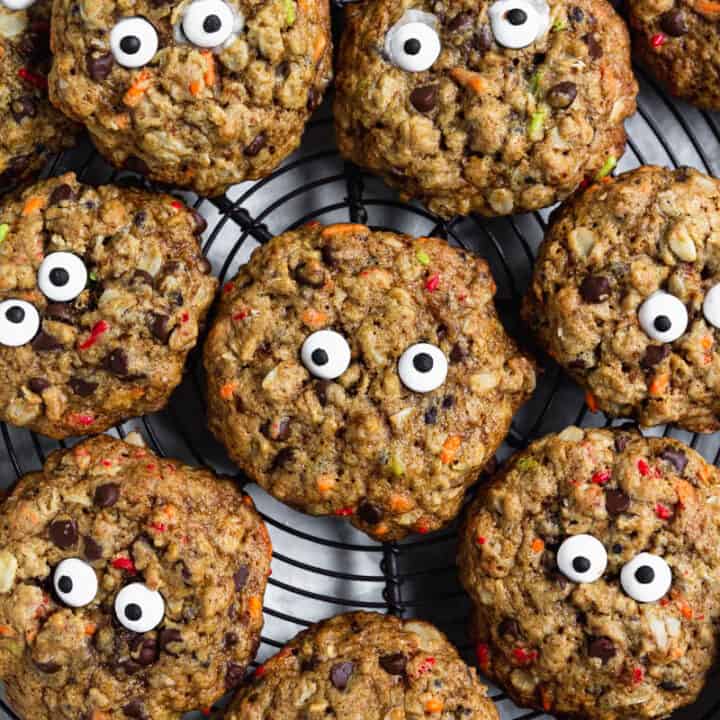 Gluten Free Monster Cookies with Candy Eyes arranged on a cooling rack