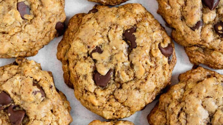 Pile of gluten free oatmeal chocolate chip cookies on a table