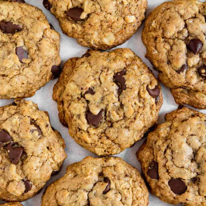 Pile of gluten free oatmeal chocolate chip cookies on a table