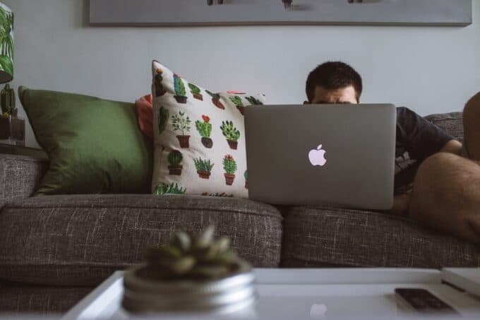 Man working on a laptop on his couch