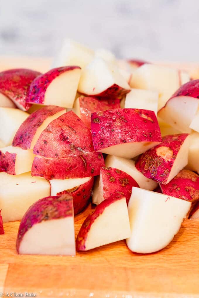 pile of chopped potatoes on a cutting board