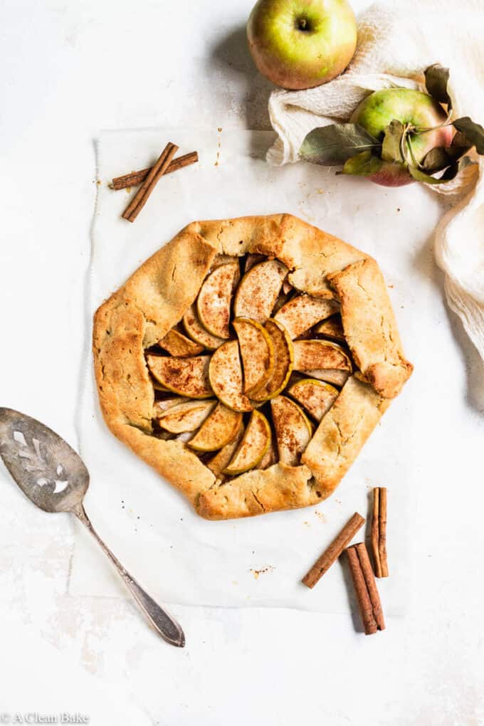 Paleo gluten free apple galette on a white table with a spatula