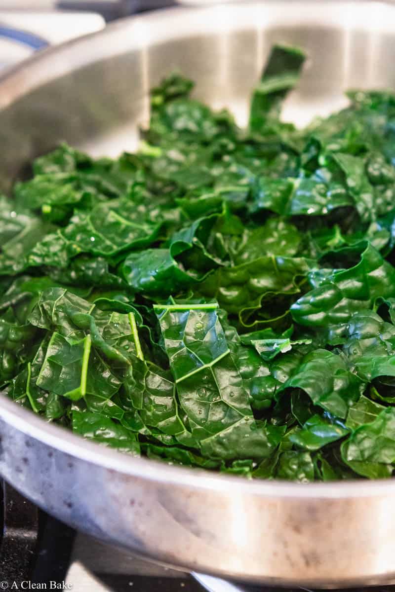 How to freeze kale: steamed kale in a large pan on the stove
