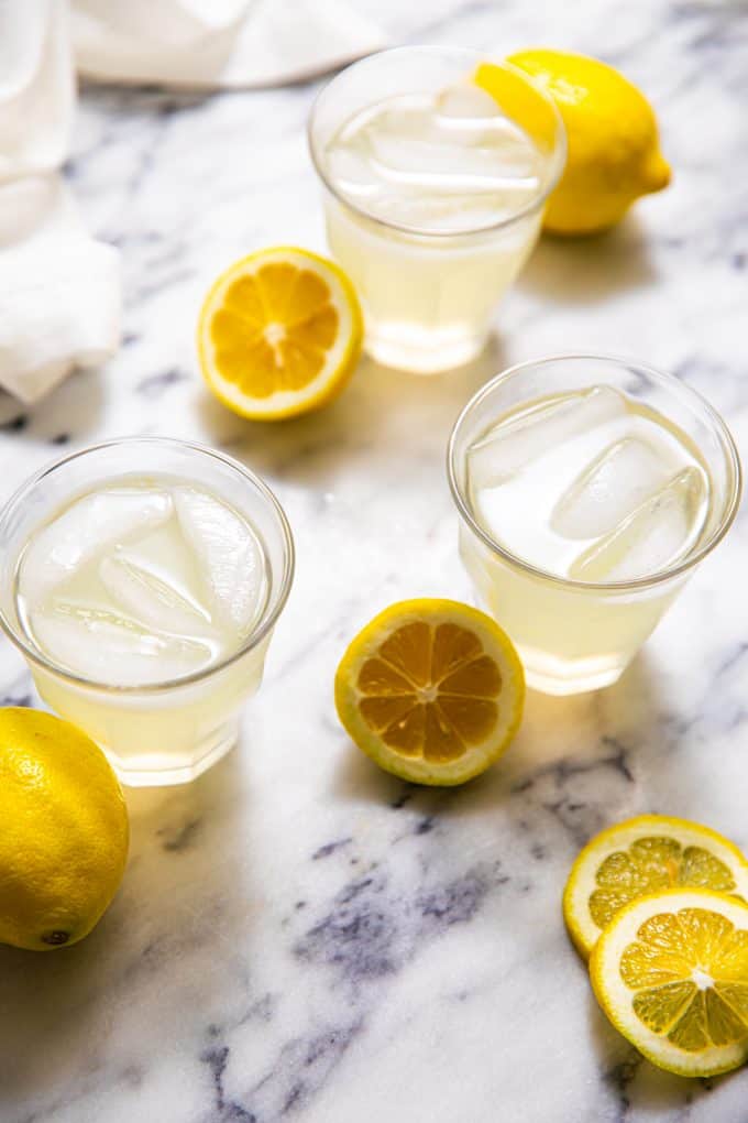 Glasses of Sugar Free Lemonade surrounded by lemons