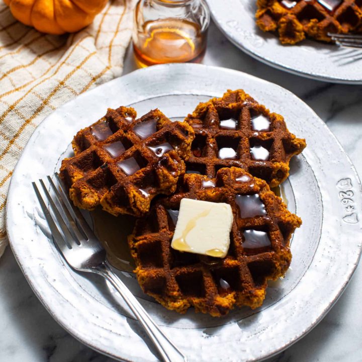 Plate of Paleo and Gluten Free Pumpkin Waffles with butter and syrup and a fork