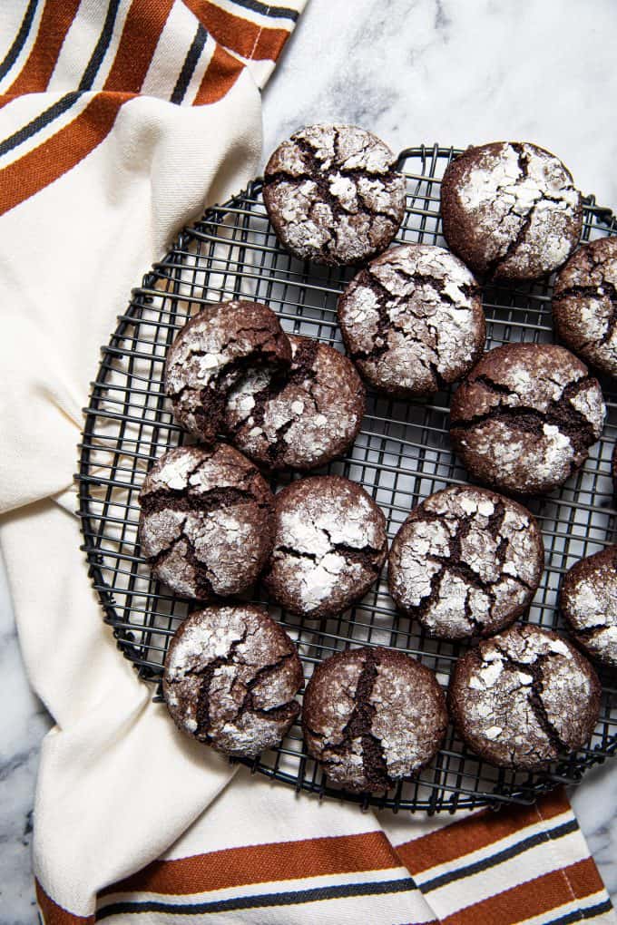 Paleo gluten free chocolate crinkle cookies on a wire cooling rack