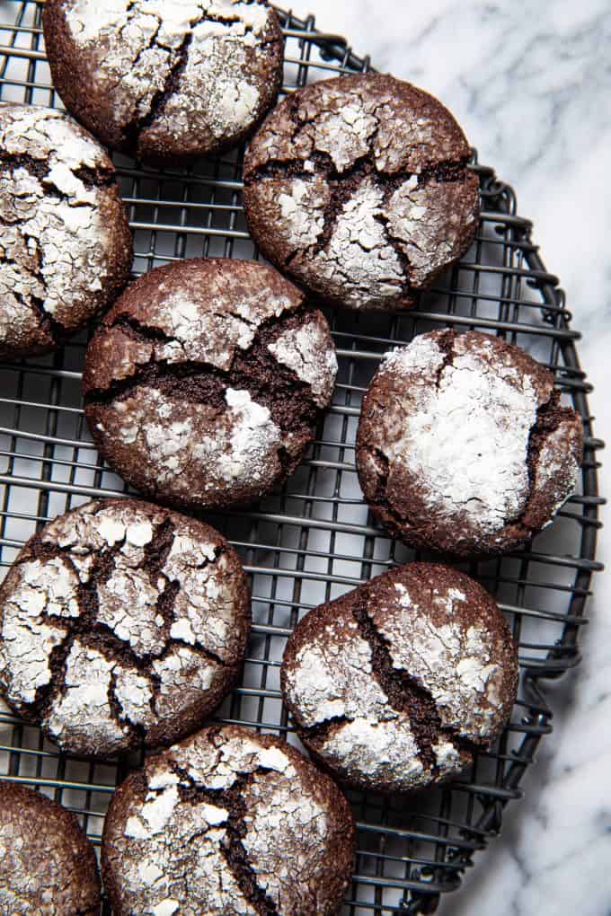 Close up of paleo gluten free chocolate crinkle cookies on a wire rack