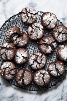 Array of Paleo gluten free chocolate crinkle cookies on a round wire rack