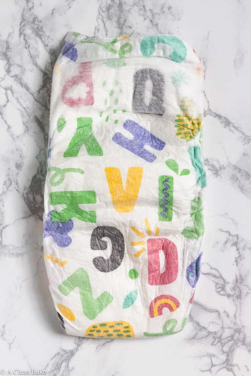 Folded Hello Bello diapers sitting on a marble tabletop