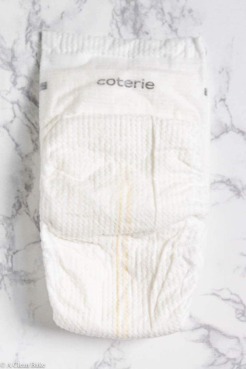 Folded Coterie diapers sitting on a marble tabletop